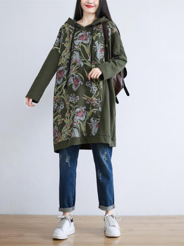 A woman wearing a green hooded mid-length