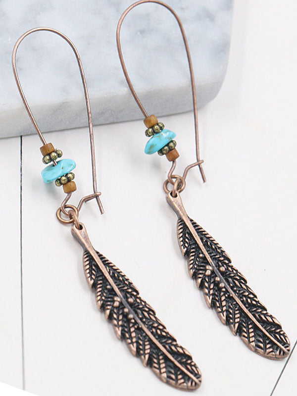 Chantent des boucles d'oreilles en plumes des ailes