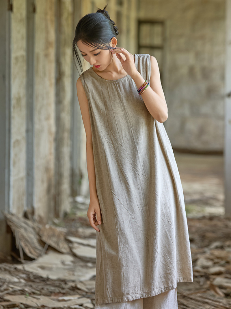 Women wearing a beige sleeveless dress 