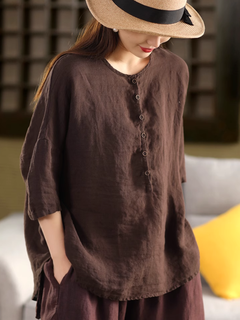 A woman wearing a Brown solid color shirt top with a classic 
