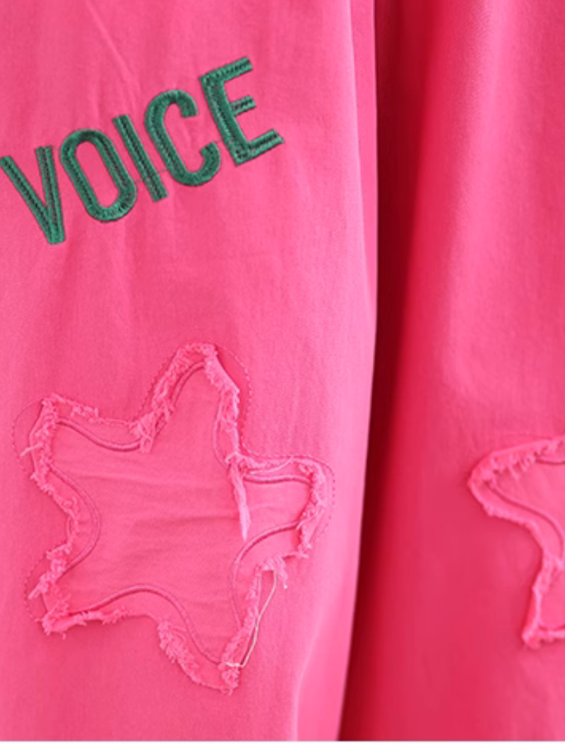 Pink garment with 'VOICE' text and heart design.