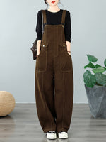 A model wearing brown wide-leg overall pants 
