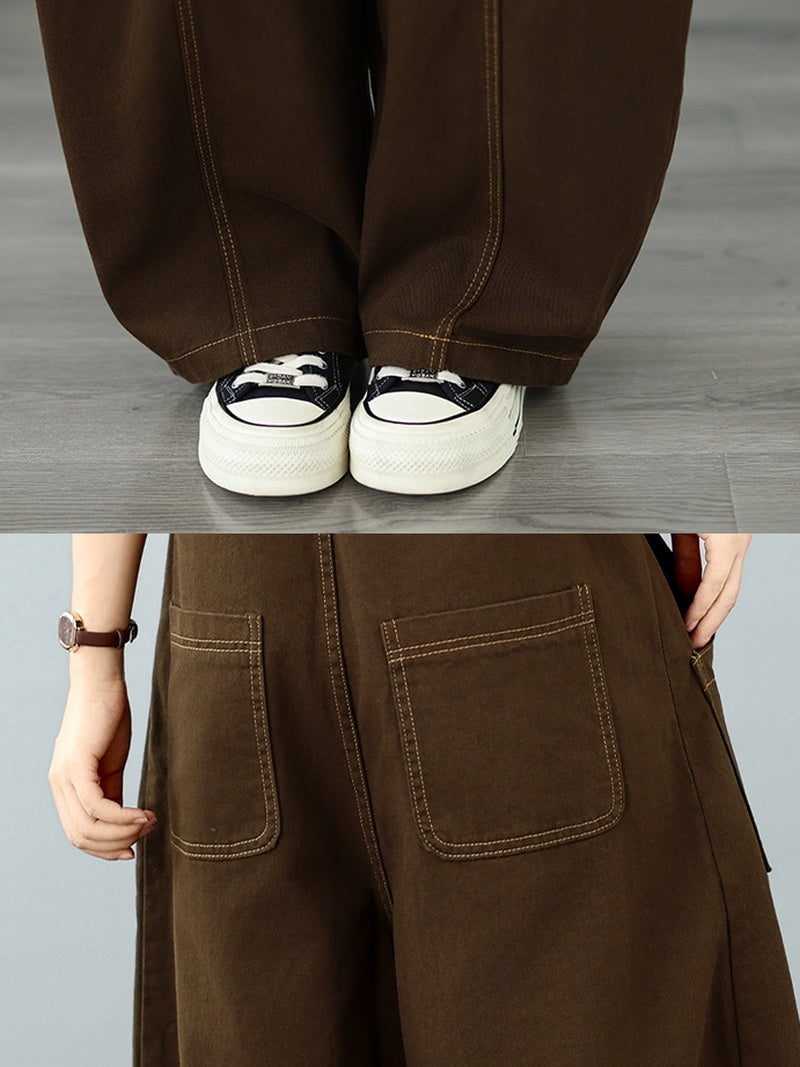A person wearing loose brown wide-leg pants. 